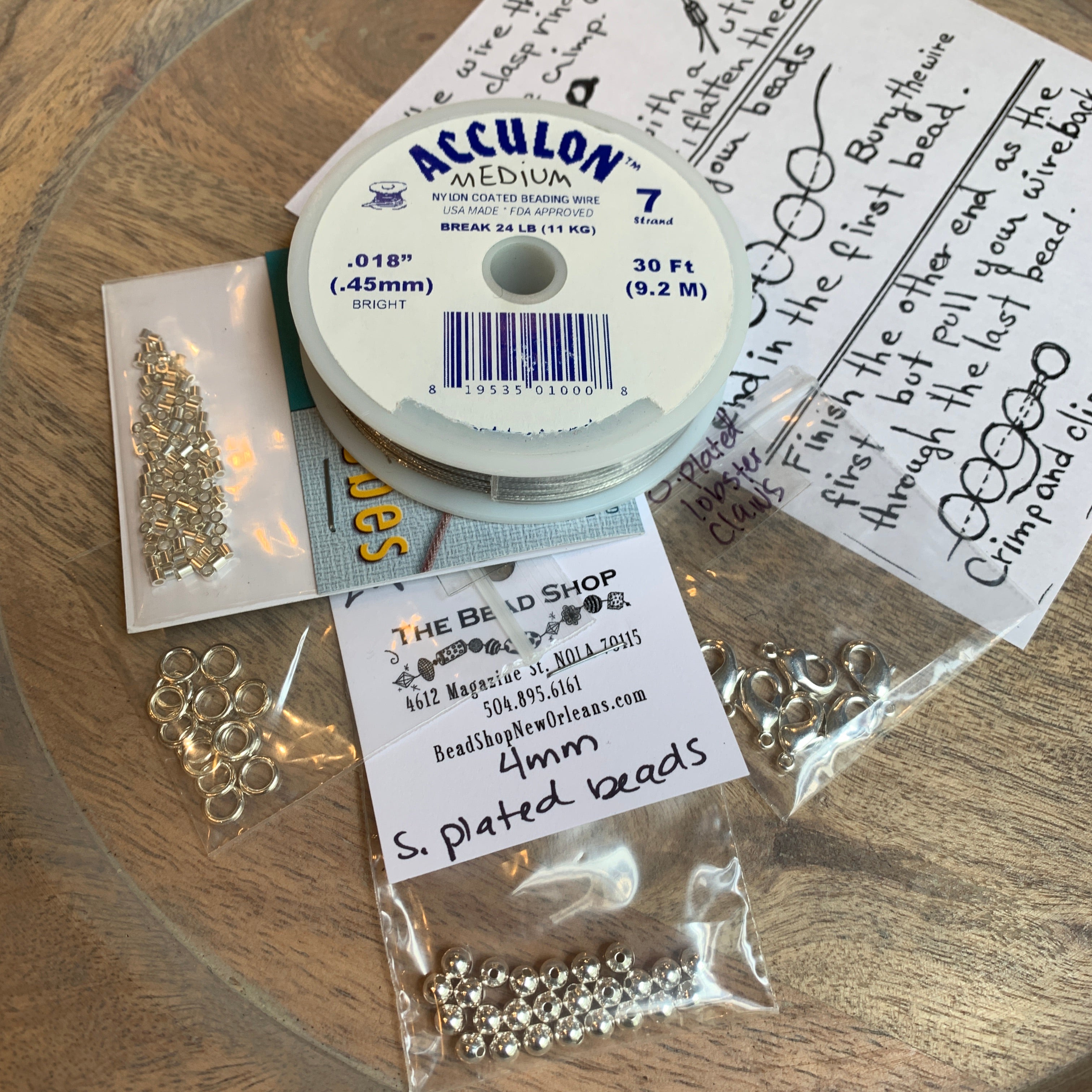 basic beading tool kit full of jewelry making supplies including chain nose pliers, soft wire cutters, beading wire, crimp beads, soldered rings, lobster claw clasps and 4mm round beads