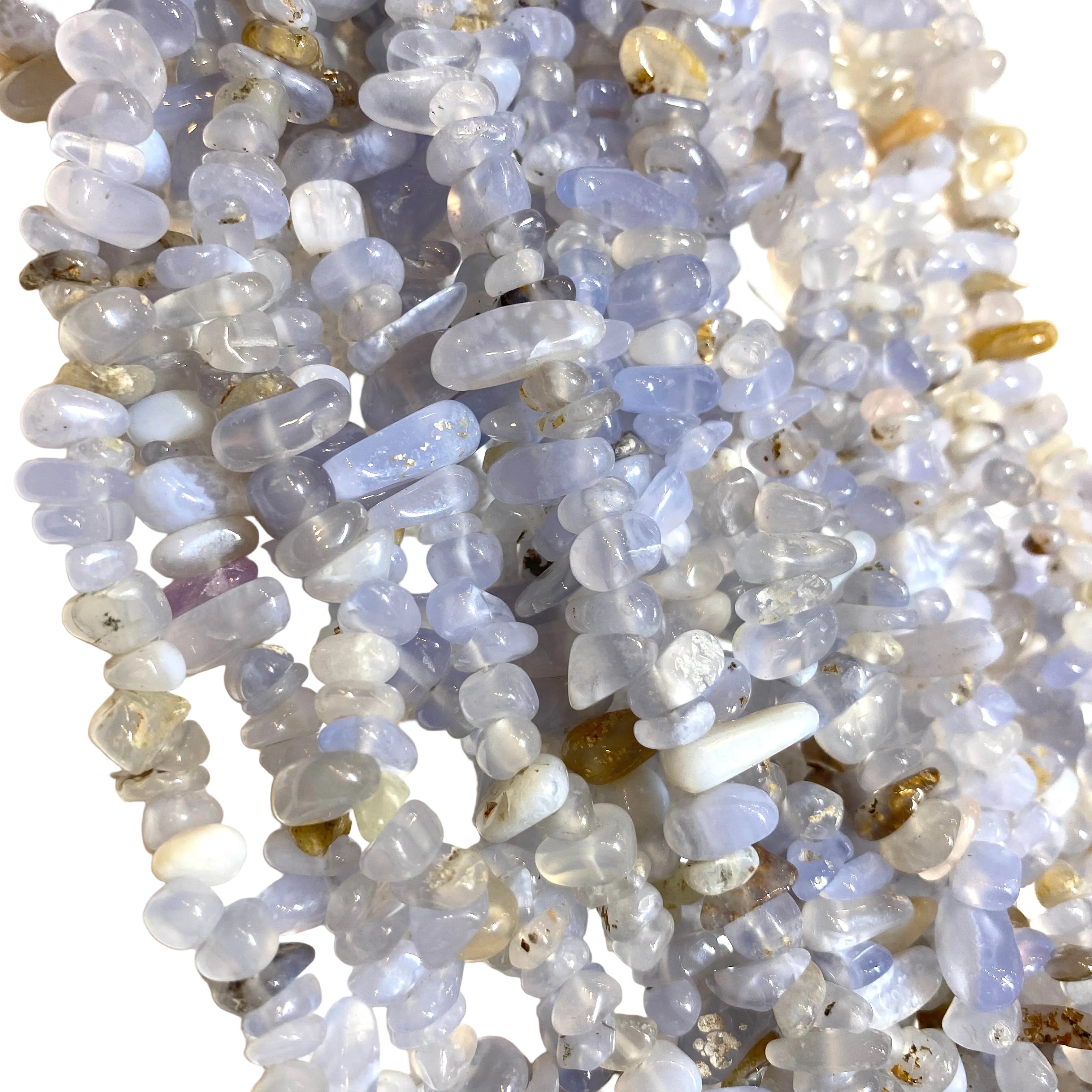 multiple strands of tumbled blue lace agate chip bead over white surface. 