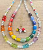 a photo of three rainbow and pearl necklaces to show how they can be worn together 