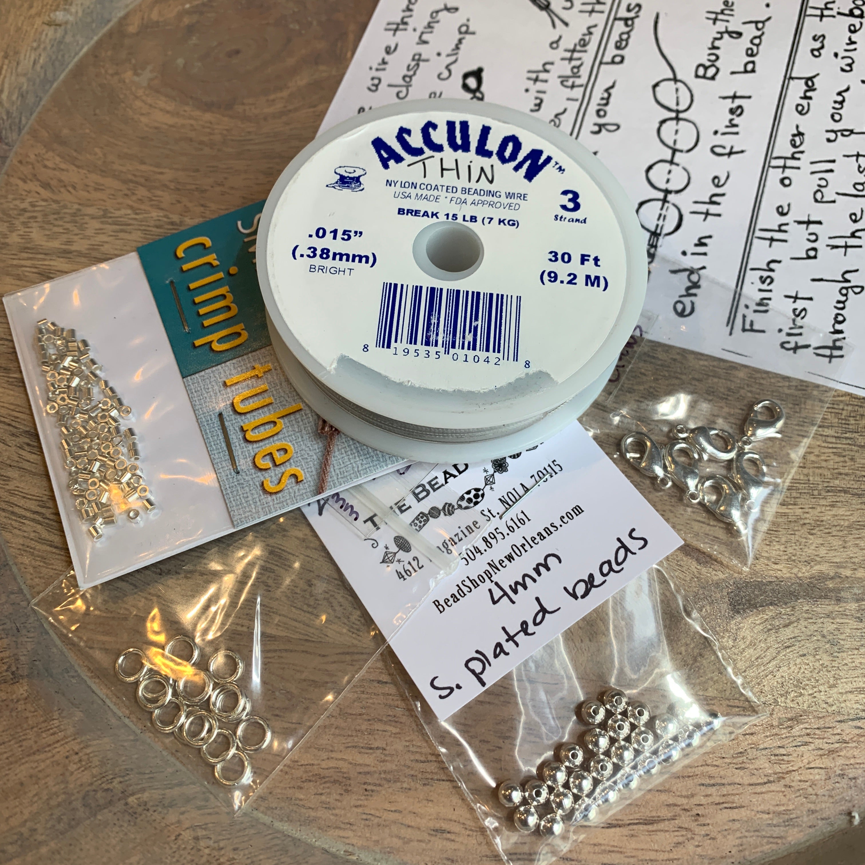 basic beading tool kit full of jewelry making supplies including chain nose pliers, soft wire cutters, beading wire, crimp beads, soldered rings, lobster claw clasps and 4mm round beads